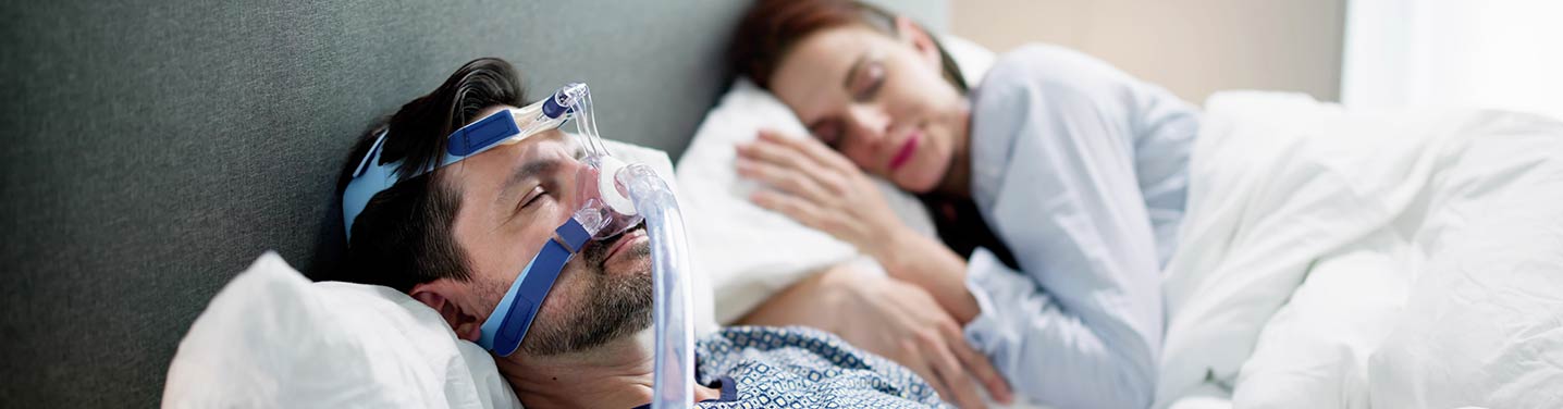 Man sleeping with a CPAP machine