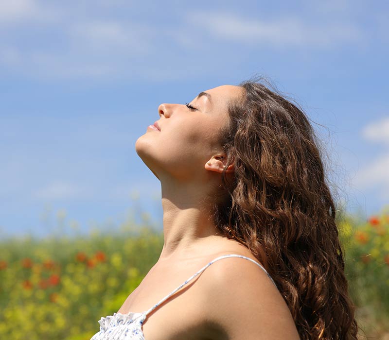 Woman breathing fresh air outside