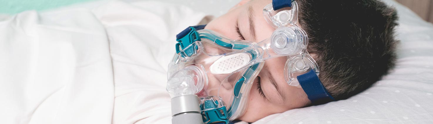 Child using a non-invasive ventilation device while sleeping.